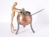 Copper fondue pot with copper rivets and iron feet